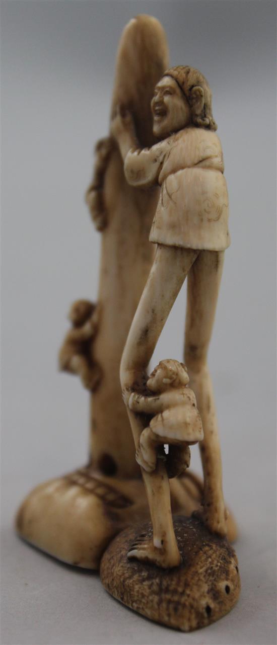 A Japanese ivory netsuke of Ashinaga holding the nose of a Tengu mask, Edo period, 6.9cm